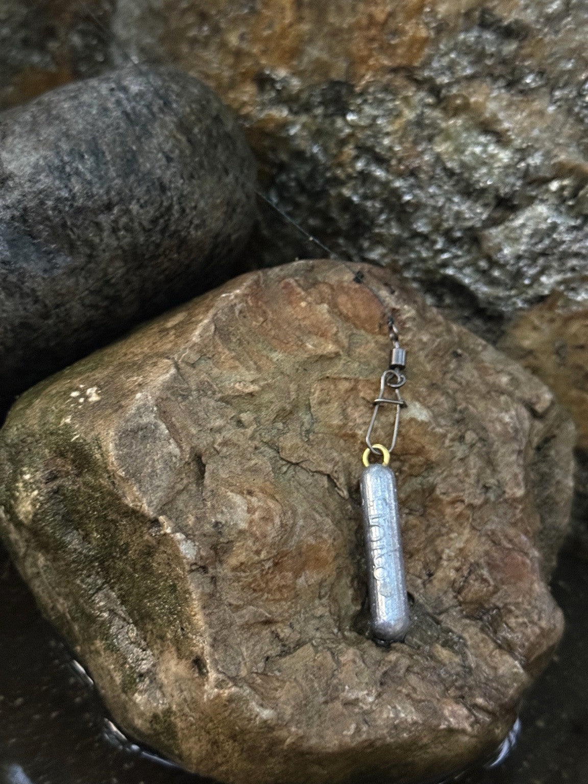 ForgeCast pencil weight on river stone
